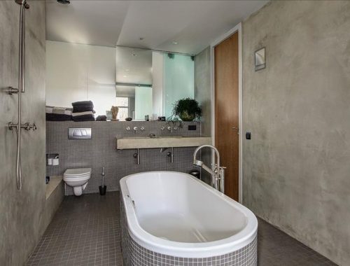 Stoere grijze badkamer met betonstuc