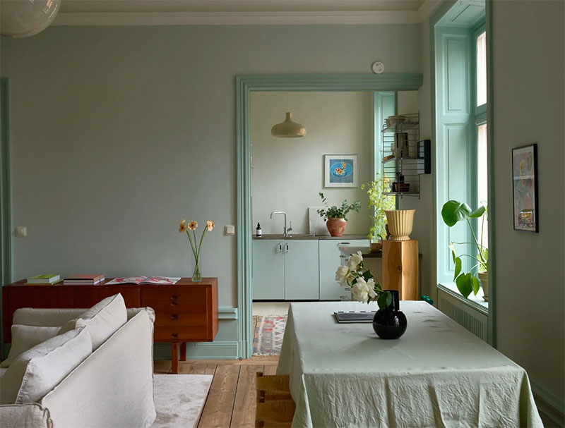 Sage green muren, gecombineerd met afwijkende groene tinten in de keuken, kozijnen, deurposten en decoratie accessoires.