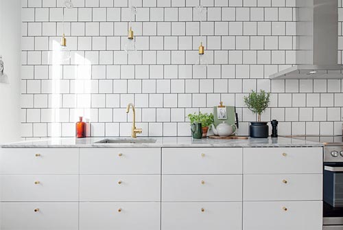 Witte kasten, marmeren werkblad en gouden deurgrepen Witte kasten, marmeren werkblad en gouden deurgrepen